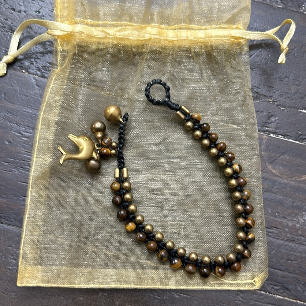 Brown and bronze colored beaded dolphin bracelet.